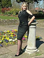 Gorgeous blonde MILF wearing a pretty black blouse and skirt, with matching pantyhose and tall stiletto heels